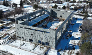 Progress of the new center as of February 2024 showing the walls up but the roof not yet on.